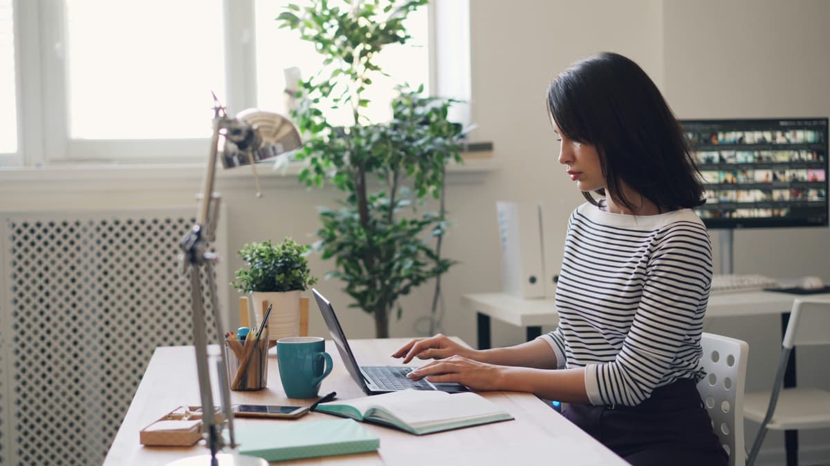 Woman working with documents on laptop
